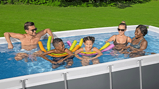A family swimming in a large swimming pool