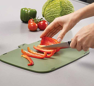 Chopping food on cutting board with a knive