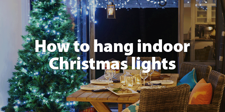 A dining room with a Christmas Tree lit up with fairy lights.
